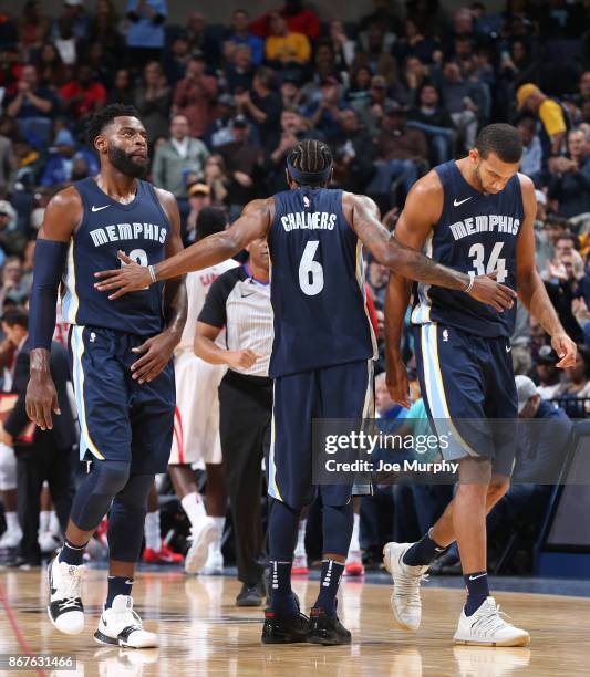 Mario Chalmers high fives Tyreke Evans and Brandan Wright of the Memphis Grizzlies during the game against the Houston Rockets on October 28, 2017 at...