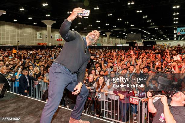 Actor Dwayne Johnson takes a selfie with the crowd at ENTERTAINMENT WEEKLY Presents Dwayne "The Rock" Johnson at Stan Lee's Los Angeles Comic-Con at...