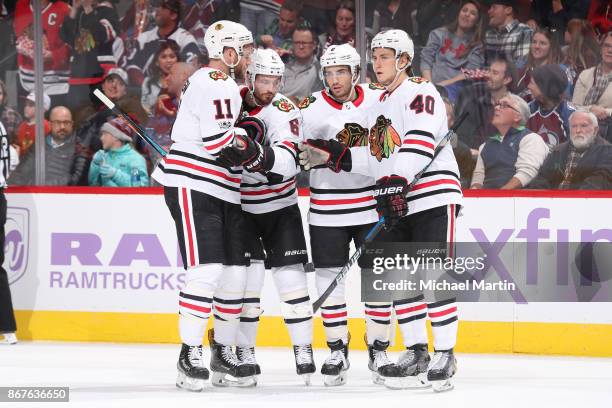 Nick Schmaltz of the Chicago Blackhawks celebrates a goal against the Colorado Avalanche with teammates: Cody Franson, John Hayden and Michael Kempny...