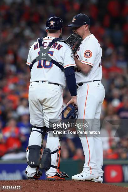 Brian McCann of the Houston Astros speaks to Will Harris during the seventh inning against the Los Angeles Dodgers in game four of the 2017 World...