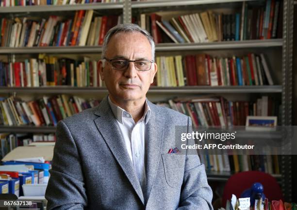 Tirana's Academy of Albania Studies director Marenglen Verli whose first name combines Marx, Engels and Lenin, poses for pictures in Tirana on...