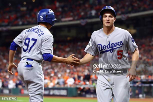 Corey Seager of the Los Angeles Dodgers celebrates after scoring on a RBI double by Cody Bellinger during the ninth inning against the Houston Astros...