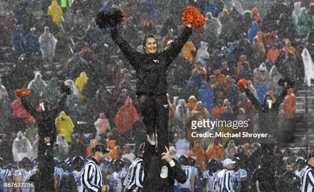 Member of the Virginia Tech Hokies cheerleading squad performs in the second half of the game against the Duke Blue Devils at Lane Stadium on October...