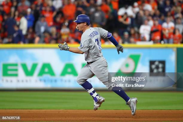 Joc Pederson of the Los Angeles Dodgers rounds the bases after a hitting a three-run home run during the ninth inning against the Houston Astros in...