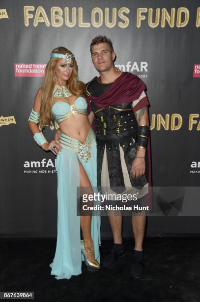 Paris Hilton and Chris Zylka attend the 2017 amfAR & The Naked Heart Foundation Fabulous Fund Fair at Skylight Clarkson Sq on October 28, 2017 in New...