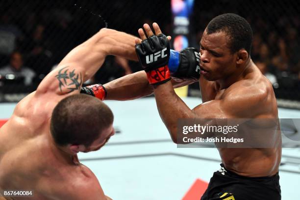 Jim Miller punches Francisco Trinaldo of Brazil in their lightweight bout during the UFC Fight Night event inside the Ibirapuera Gymnasium on October...