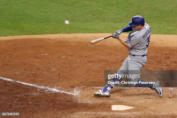 Joc Pederson of the Los Angeles Dodgers hits a three-run home run during the ninth inning against the Houston Astros in game four of the 2017 World...