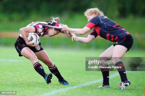 Grace Brooker of Canterbury pulls Serai Murray-Wihongi of Counties Manukau over the sideline during the Farah Palmer Cup Premiership Final match...
