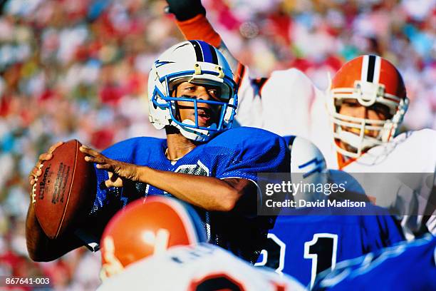 american football, quarterback looking to pass (digital composite) - quarterback player stock pictures, royalty-free photos & images