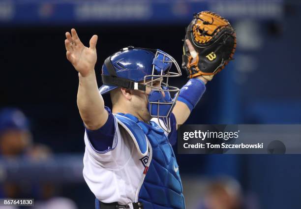 Miguel Montero of the Toronto Blue Jays motions to infielders during MLB game action against the Oakland Athletics at Rogers Centre on July 26, 2017...