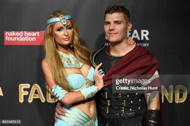 Paris Hilton and Chris Zylka attend the 2017 amfAR & The Naked Heart Foundation Fabulous Fund Fair at Skylight Clarkson Sq on October 28, 2017 in New...