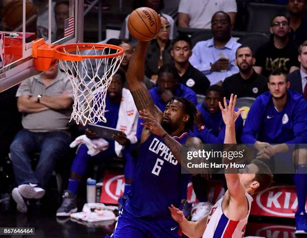 DeAndre Jordan of the LA Clippers dunks past Jon Leuer of the Detroit Pistons during the first half at Staples Center on October 28, 2017 in Los...