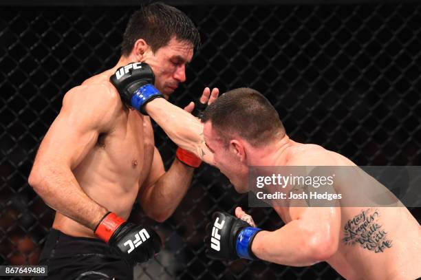 Colby Covington punches Demian Maia of Brazil in their welterweight bout during the UFC Fight Night event inside the Ibirapuera Gymnasium on October...