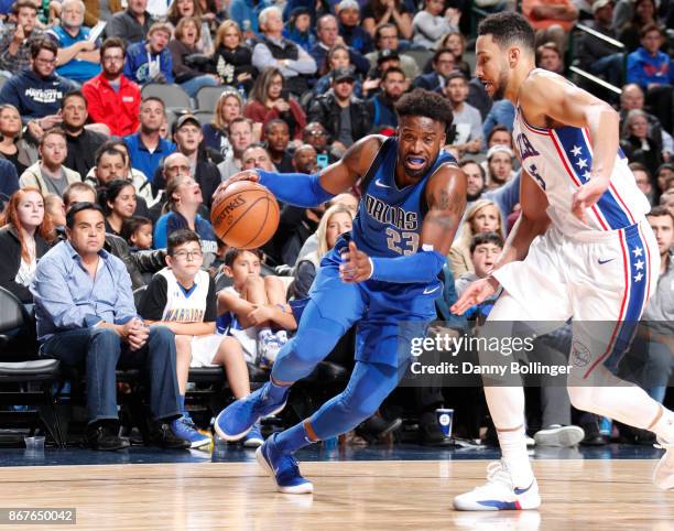 Wesley Matthews of the Dallas Mavericks handles the ball against Ben Simmons of the Philadelphia 76ers on October 28, 2017 at the American Airlines...