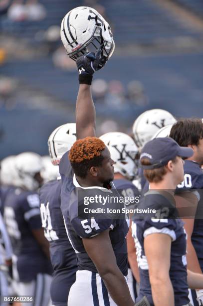 Yale Bulldogs defensive lineman Julian Fraser holds his helmet high during the game between the Yale Bulldogs and the Columbia Lions on October 28,...