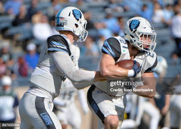 Columbia Lions quarterback Anders Hill hands the ball off to Columbia Lions running back Chris Schroer during the game between the Yale Bulldogs and...