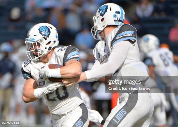 Columbia Lions quarterback Anders Hill hands the ball off to Columbia Lions running back Tanner Thomas during the game between the Yale Bulldogs and...