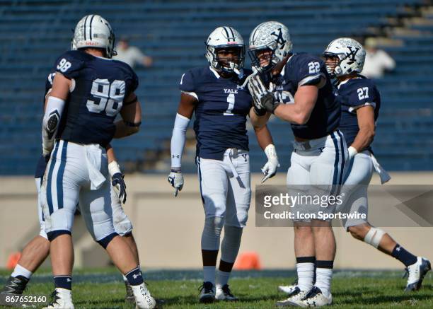 Yale Bulldogs outside linebacker Matthew Oplinger celebrates with teammates after getting a QB sack during the game between the Yale Bulldogs and the...