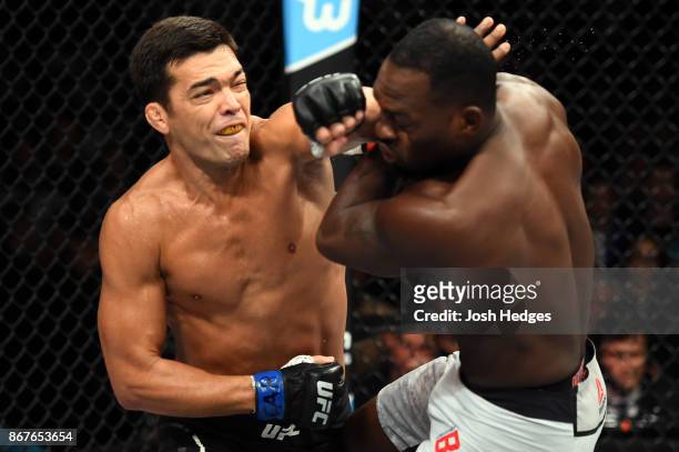 Lyoto Machida of Brazil punches Derek Brunson in their middleweight bout during the UFC Fight Night event inside the Ibirapuera Gymnasium on October...