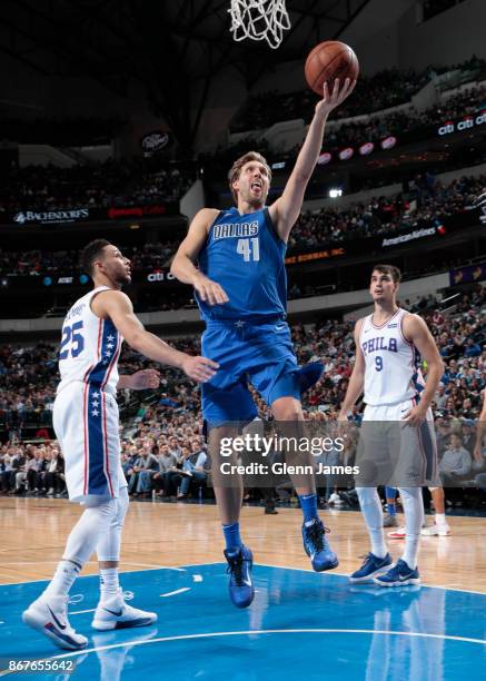 Dirk Nowitzki of the Dallas Mavericks drives to the basket against the Philadelphia 76ers on October 28, 2017 at the American Airlines Center in...