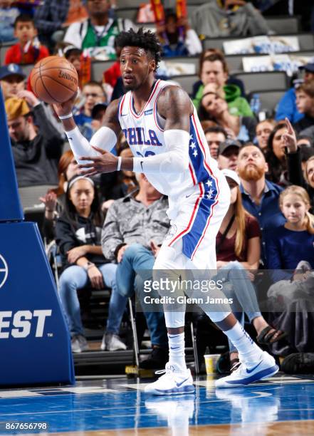 Robert Covington of the Philadelphia 76ers passes the ball against the Dallas Mavericks on October 28, 2017 at the American Airlines Center in...