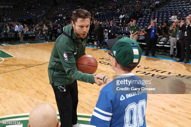 Milwaukee, WI Mirza Teletovic of the Milwaukee Bucks speaks with a fan during the game against the Cleveland Cavaliers on October 20, 2017 at the BMO...