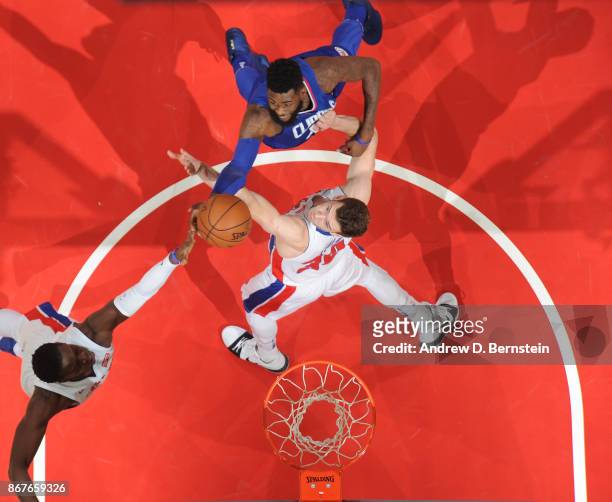 Willie Reed of the LA Clippers goes up for a rebound against Jon Leuer and Reggie Jackson of the Detroit Pistons on October 28, 2017 at STAPLES...