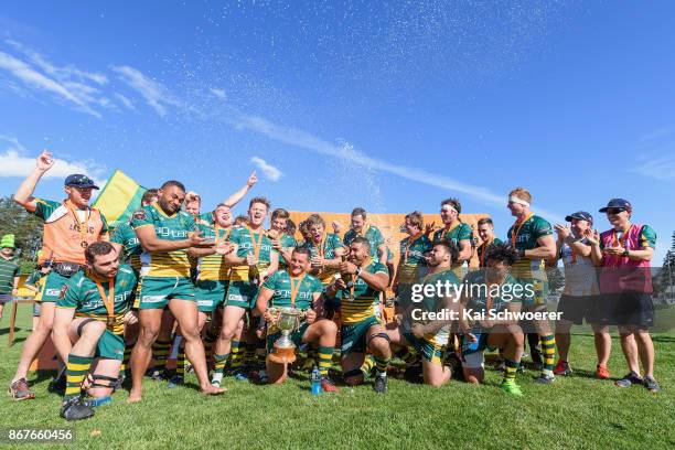 Captain Jackson Donlan of Mid Canterbury and his team mates celebrate with the Lochore Cup after their win in the Mitre 10 Heartland Championship...