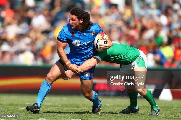 Brenden Santi of Italy is tackled during the 2017 Rugby League World Cup match between Ireland and Italy at Barlow Park on October 29, 2017 in...