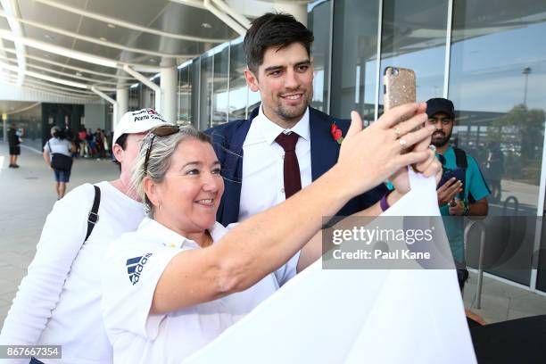 Alistair Cook of England poses for photos with supporters on arrival at Perth Airport with the England Test squad on October 29, 2017 in Perth,...