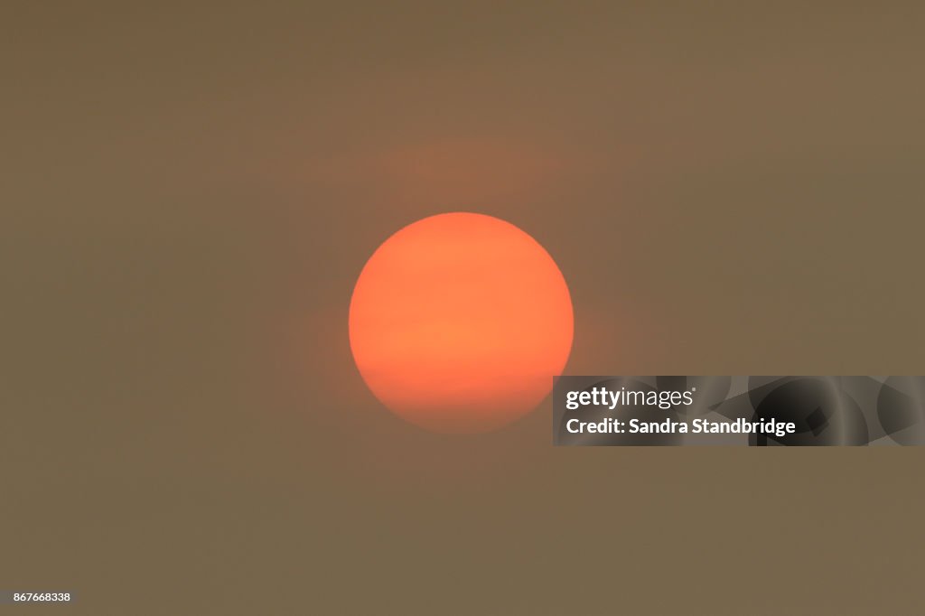 The Sun colour in the Uk was due to a weather phenomenon, Saharan dust, blown in by ex-hurricane Ophelia and also from debris, caused by fires in Portugal and Spain.