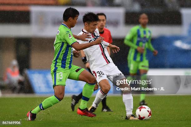 Yuta Toyokawa of Fagiano Okayama and Miki Yamane of Shonan Bellmare compete for the ball during the J.League J2 match between Shonan Bellmare and...