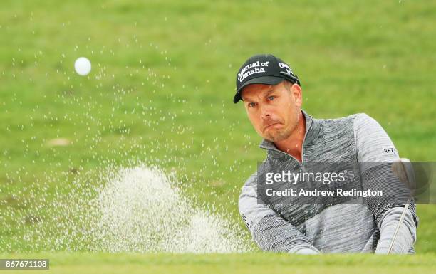 Henrik Stenson of Sweden plays his third shot from a bunker on the 14th hole during the final round of the WGC - HSBC Champions at Sheshan...