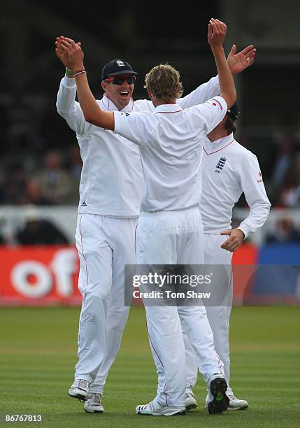 Kevin Pietersen of England congratulates Stuart Broad after he took the wicket of Denesh Ramdin of West Indies during day three of the 1st npower...