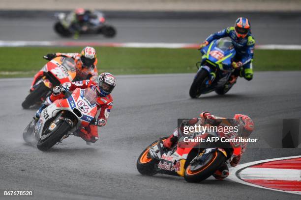 Repsol Hondas Spanish rider Marc Marquez leads the pack during the start of the Malaysia MotoGP at the Sepang International circuit on October 29,...