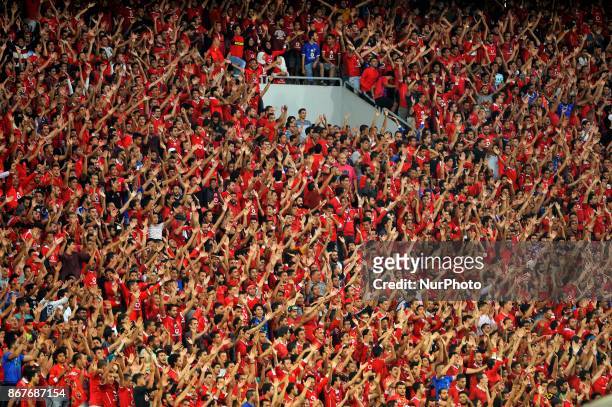 Al-Ahly supporters cheer for their team during the CAF Champions League final football match between Al-Ahly vs Wydad Casablanca at the Borg El Arab...