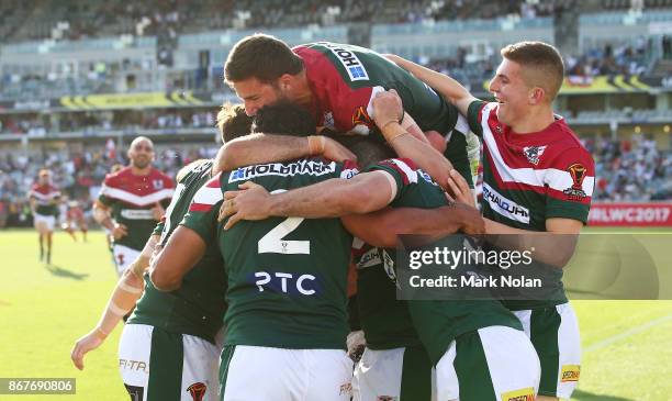 Lebanon players celebrate a try by Travis Robinson of Lebanon during the 2017 Rugby League World Cup match between France and Lebanon at Canberra...