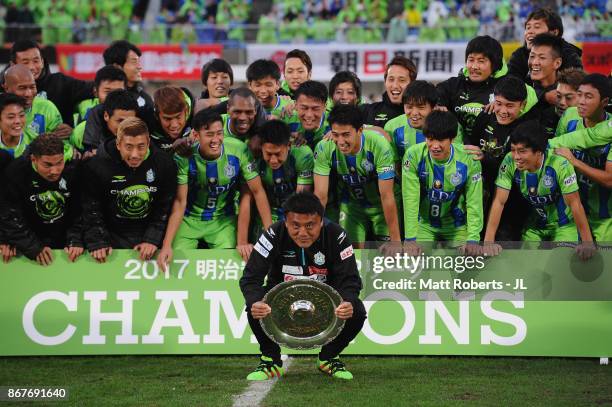 Head coach Cho Kwi Jae of Shonan Bellmare lifts the trophy as they celerbrate J2 champions and promotion to J1 after the J.League J2 match between...