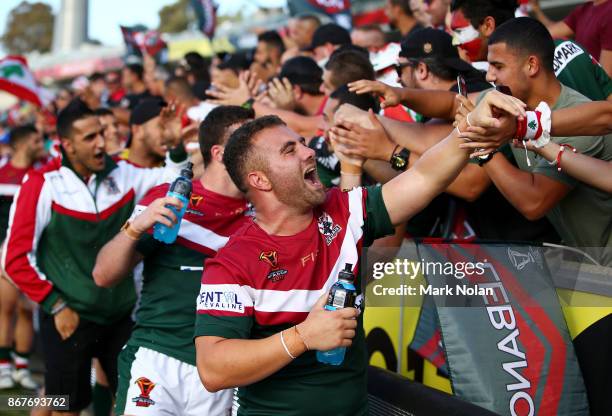 Lebanon players celebrate with fans after winning the 2017 Rugby League World Cup match between France and Lebanon at Canberra Stadium on October 29,...