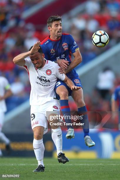 Jason Hoffman of the Jets contests the ball with Mark Bridge of the Wanderers during the round four A-League match between the Newcastle Jets and the...