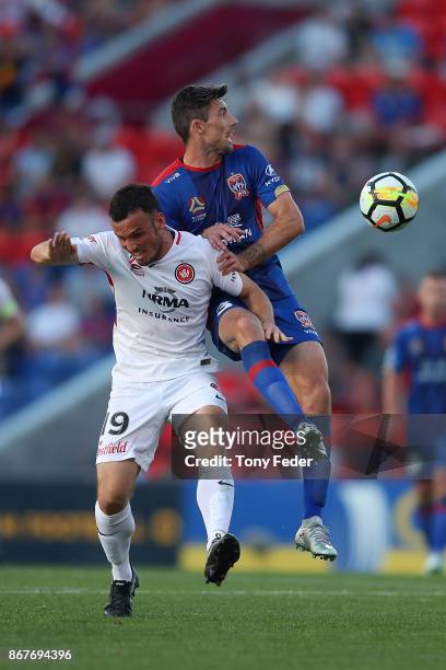 Jason Hoffman of the Jets contests the ball with Mark Bridge of the Wanderers during the round four A-League match between the Newcastle Jets and the...