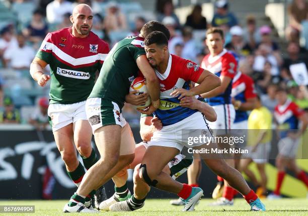 Fouad Taha of France is tackled during the 2017 Rugby League World Cup match between France and Lebanon at Canberra Stadium on October 29, 2017 in...