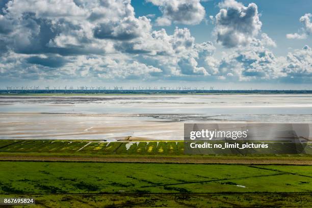 wind turbines along the north sea coastline - wattenmeer national park stock pictures, royalty-free photos & images