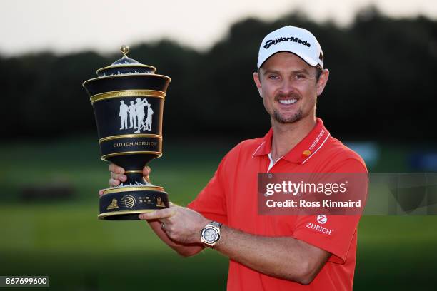 Justin Rose of England celebrates with the Old Tom Morris Cup after finishing 14 under to win the WGC - HSBC Champions at Sheshan International Golf...