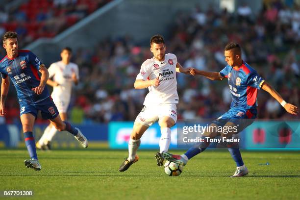 Joseph Champness of the Jets contests the ball with Joshua Risdon of the Wanderers during the round four A-League match between the Newcastle Jets...