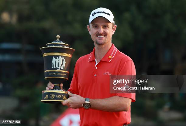 Justin Rose of England celebrates with the Old Tom Morris Cup after finishing 14 under to win the WGC - HSBC Champions at Sheshan International Golf...