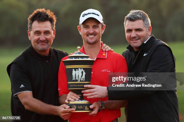 Justin Rose of England celebrates with the Old Tom Morris Cup and caddie Mark Fulcher and agent Paul McDonnell after finishing 14 under to win the...