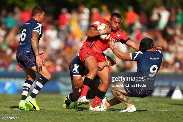 Sio Siua Taukeiaho of Tonga is tackled during the 2017 Rugby League World Cup match between Scotland and Tonga at Barlow Park on October 29, 2017 in...