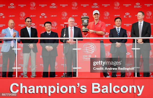 Justin Rose of England celebrates with the Old Tom Morris Cup on the Champion's Balcony after finishing 14 under to win the WGC - HSBC Champions at...