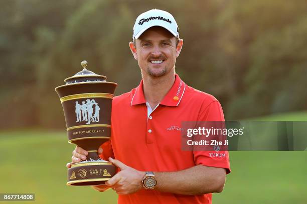 Justin Rose of England celebrates with the Old Tom Morris Cup after finishing 14 under to win the WGC - HSBC Champions at Sheshan International Golf...